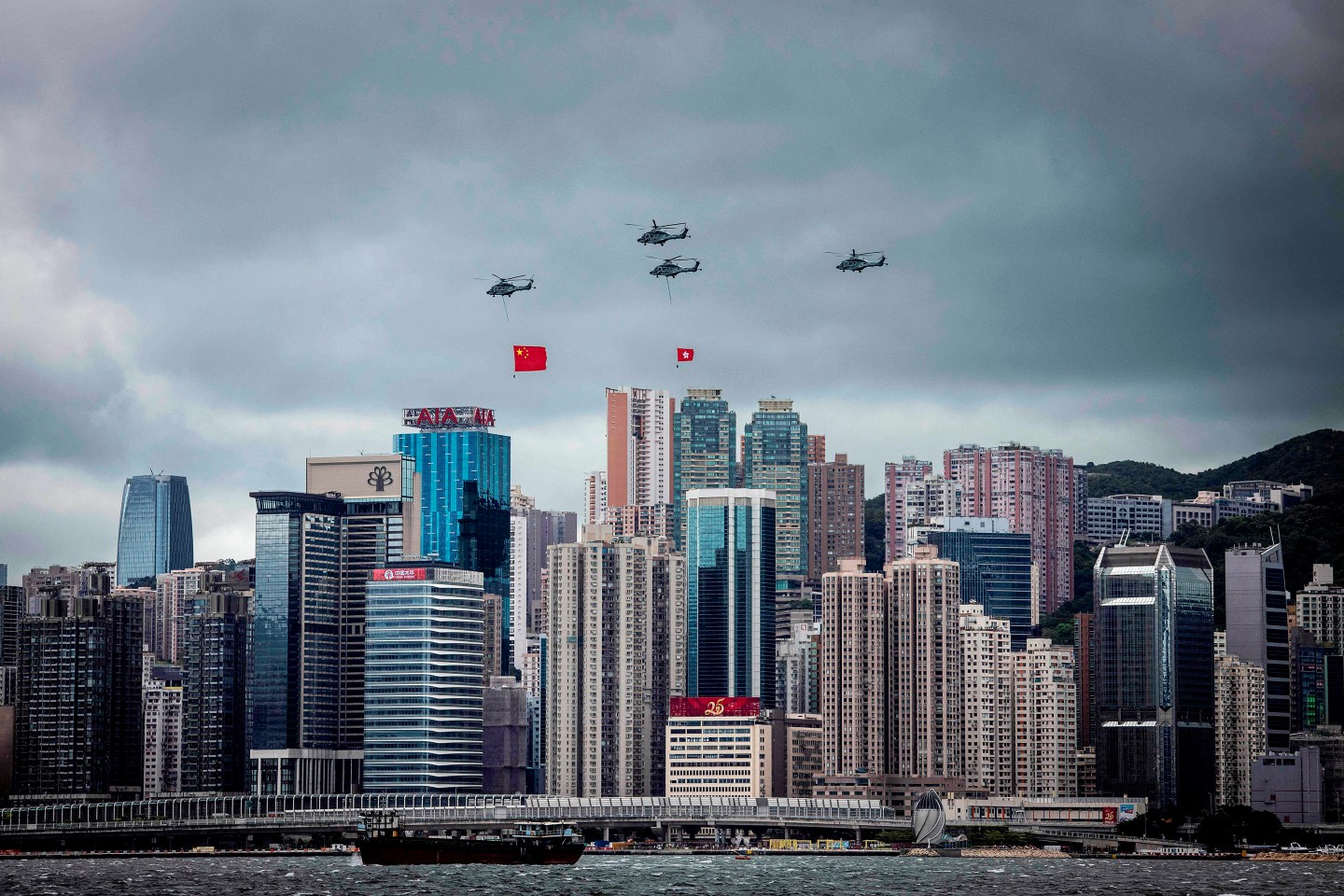 Helicopters fly past with the Hong Kong and Chinese flags during a flag-raising ceremony to celebrate the 25th anniversary of the city's handover from Britain to China.