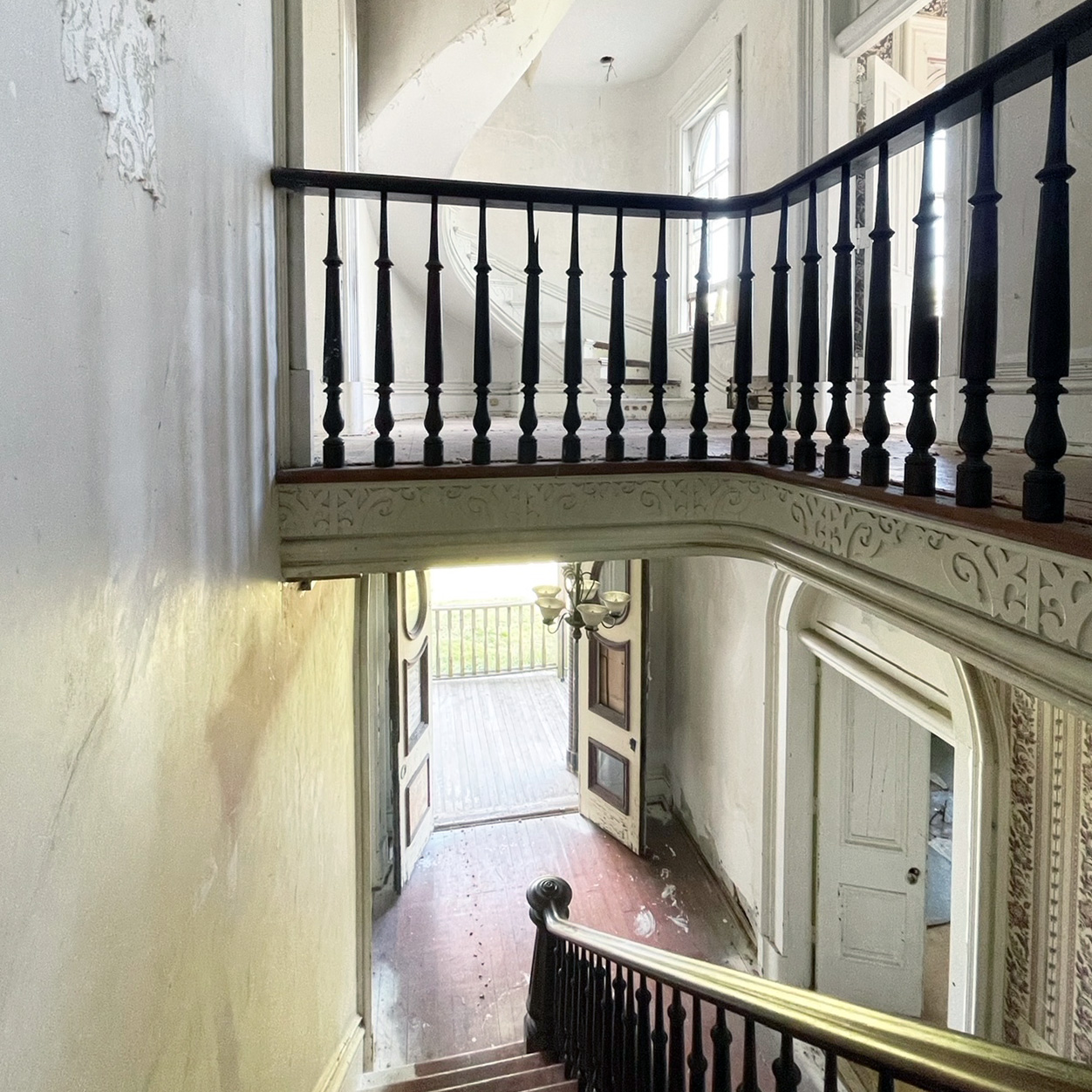 A view from the staircase into the foyer.