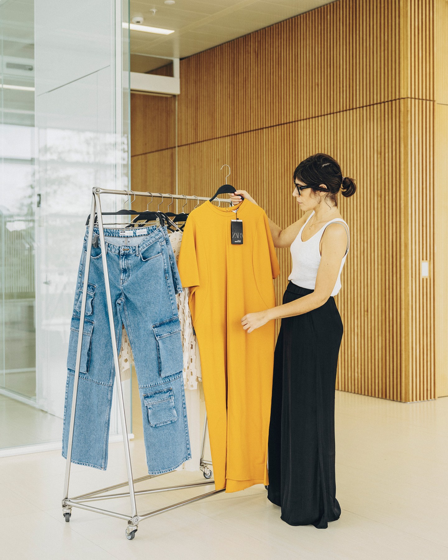 Sham Sharif Sokker (Corporate Sustainability Lead at Inditex) inspects a rack of sustainable garments at the Inditex HQ.