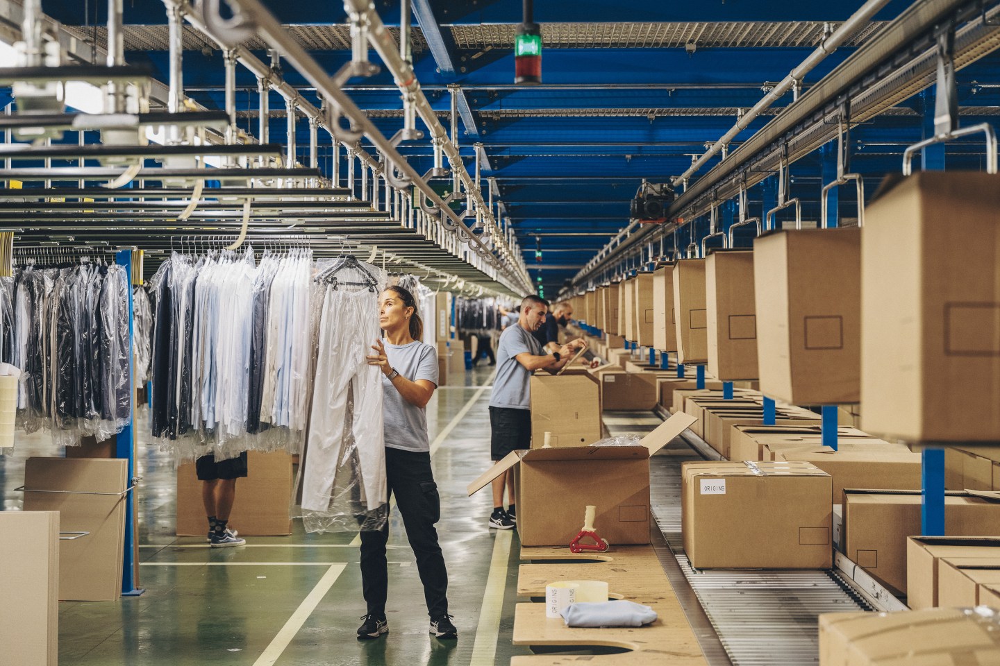 Inditex employees pack boxes with garments in the logistics centre.