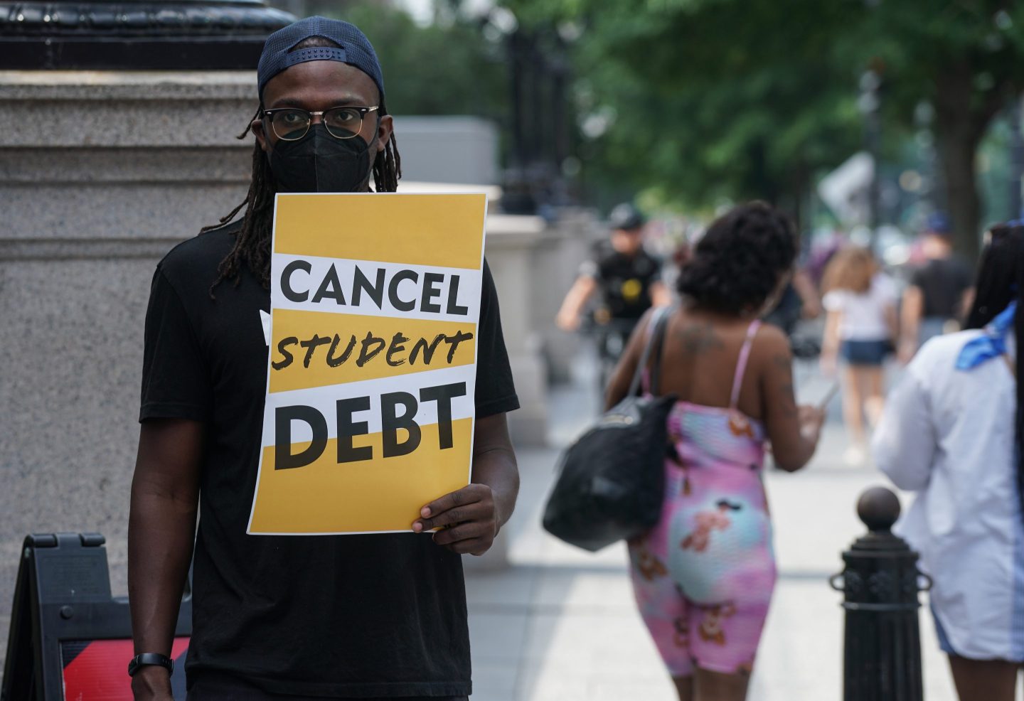 Student loan debt holders take part in a demonstration outside of the white house staff entrance to demand that President Biden cancel student loan debt in August on July 27, 2022 at the Executive Offices in Washington, DC.