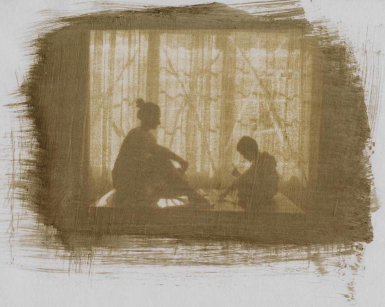 woman and child sitting next to window