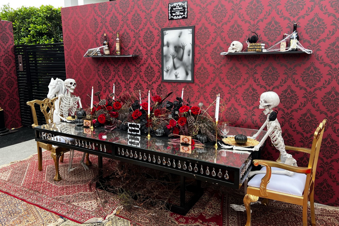 Skeletons sitting at a table.