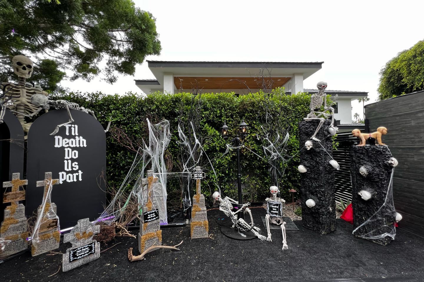A mock graveyard that’s part of a Halloween display in front of a house.