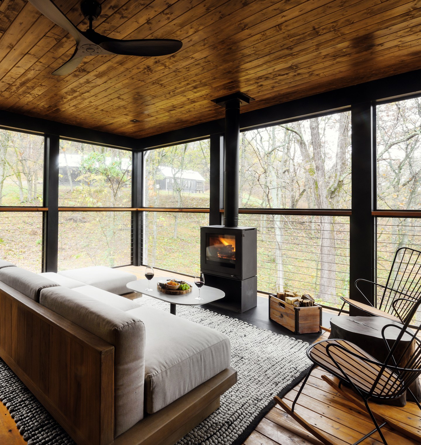 Interior view of Southall's Hillside two bedroom cottage with fireplace and cozy couch.