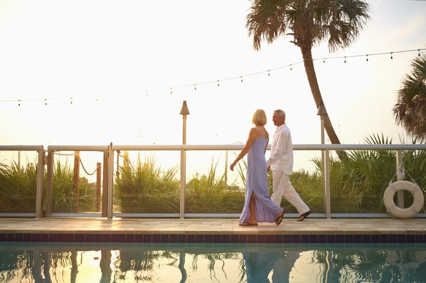 couple walking on the beach at sunset