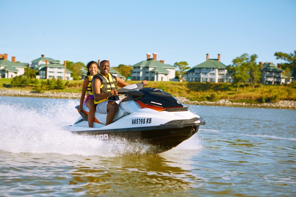 Father and daughter enjoy jet ski on James River at Kingsmill Resort.