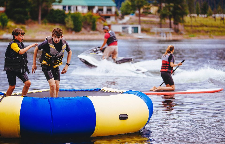 Family enjoying water activities at The Resort at Paws Up in Greenough, Montana