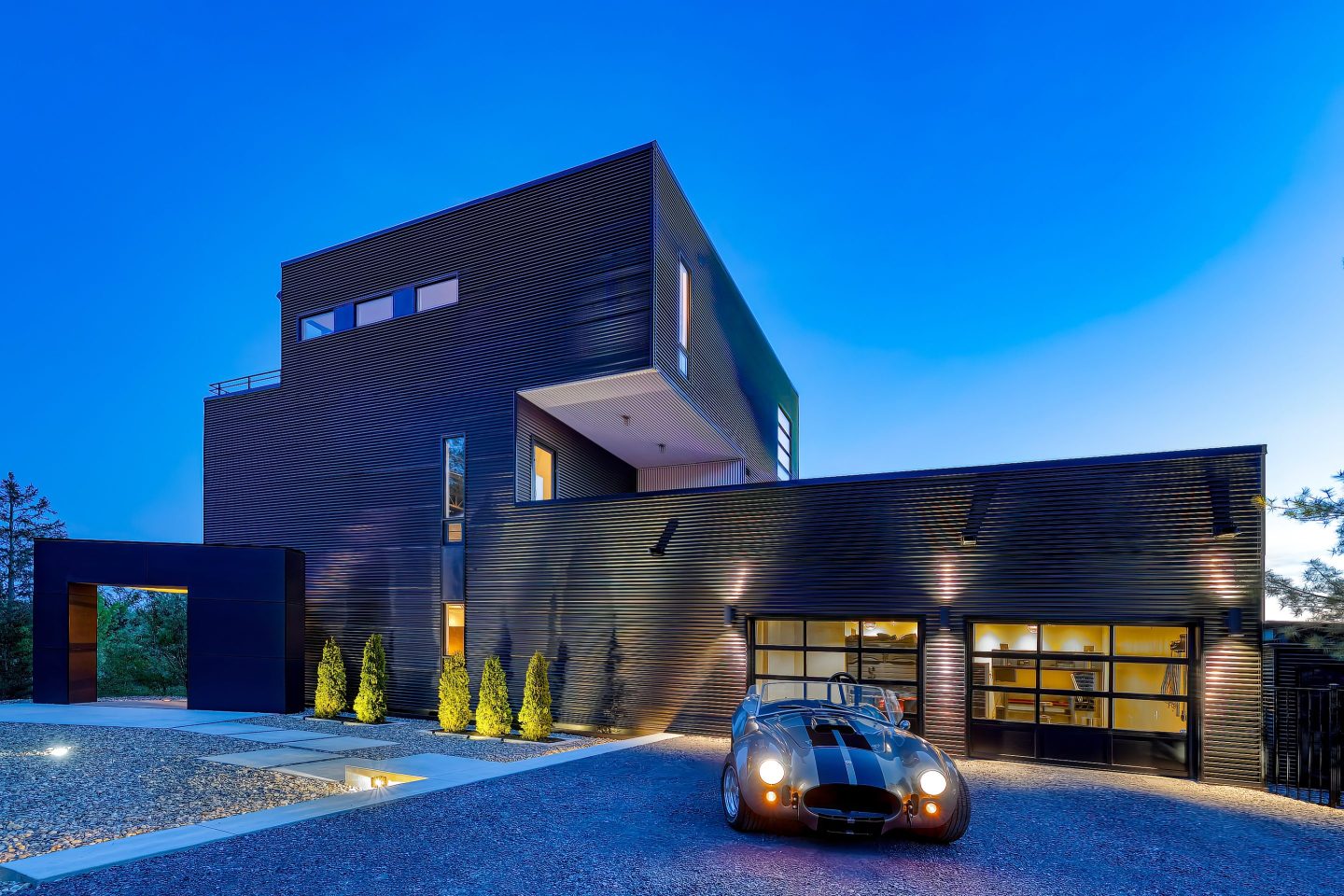 Picture of a villa with a car parked in front of it