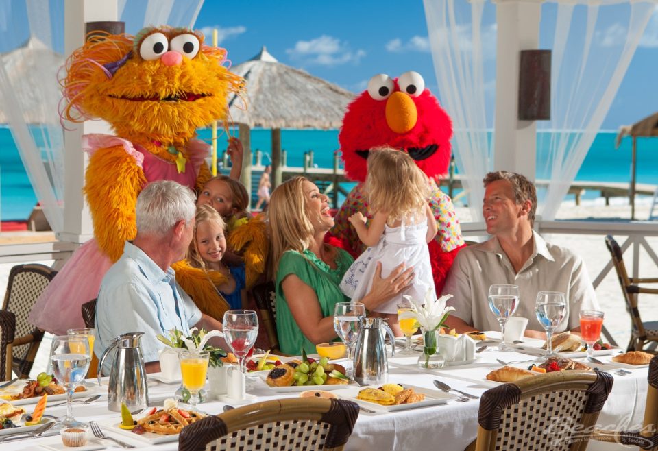 Family enjoying breakfast with Sesame Street characters at Beaches in Turks & Caicos.