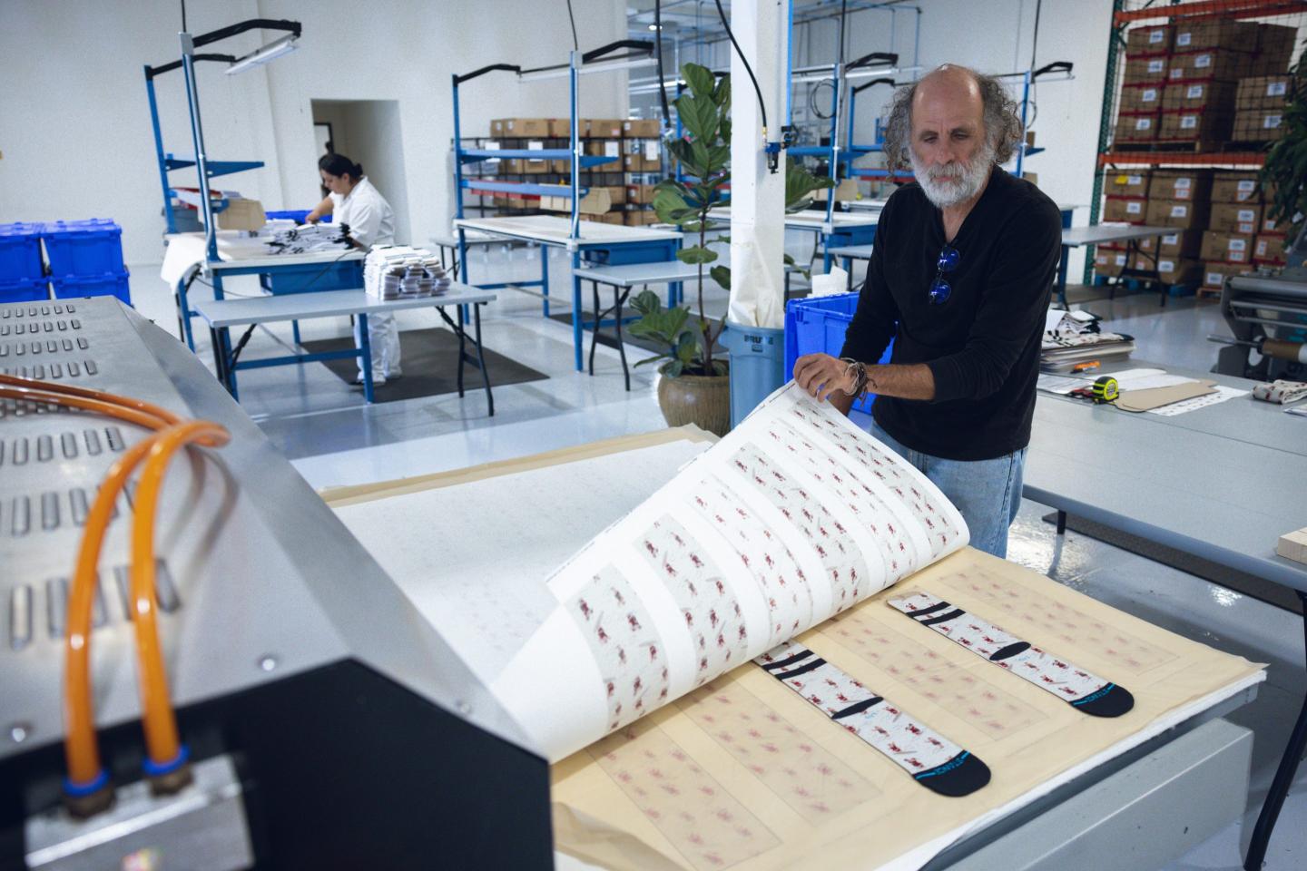 Factory worker operating printing machine