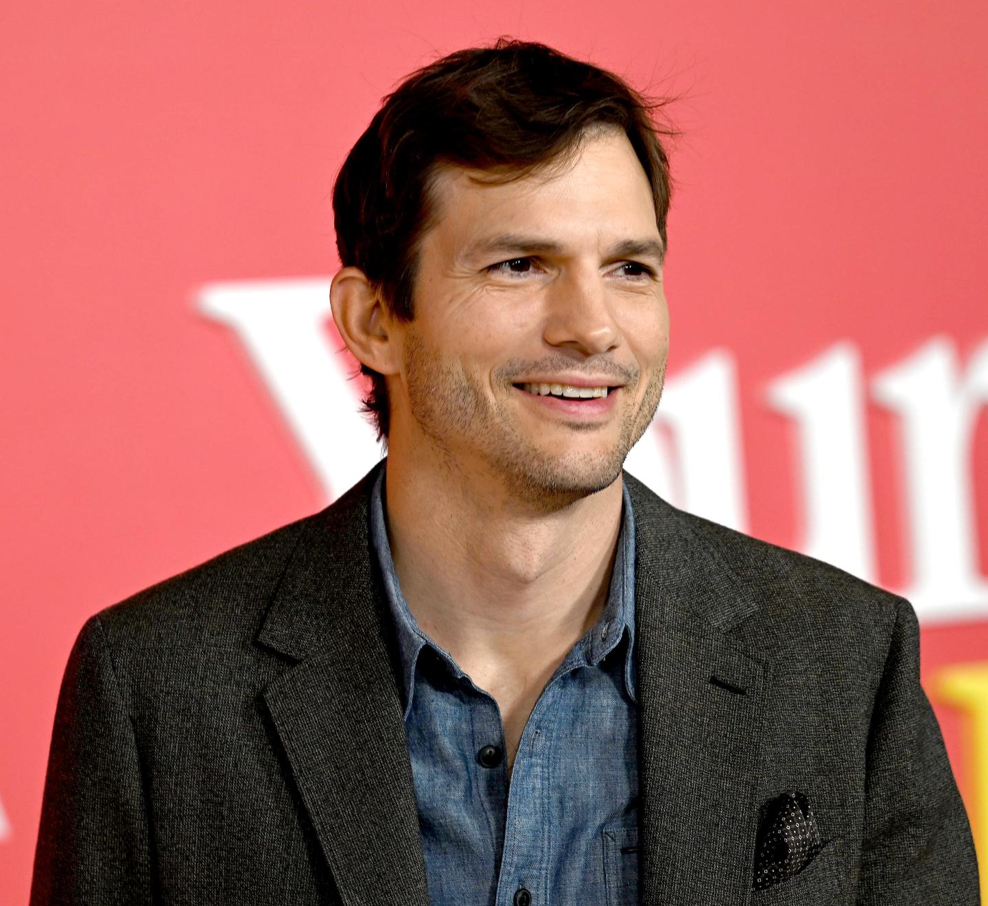 Ashton Kutcher poses for the press at a movie premiere