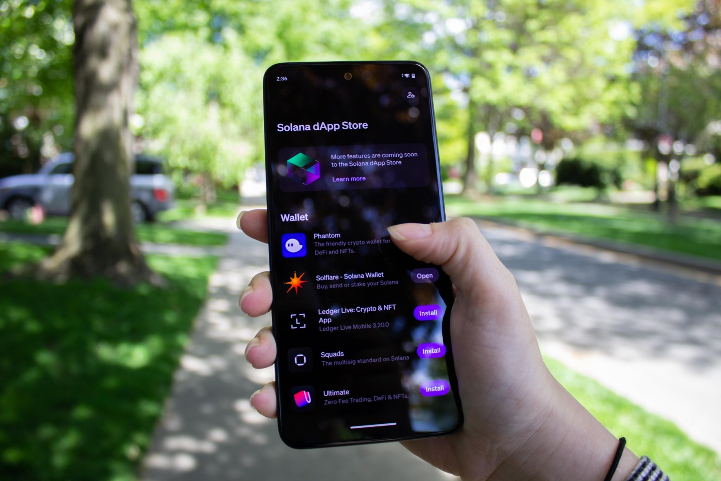 Someone holds the Solana Saga as its dApp store is open.