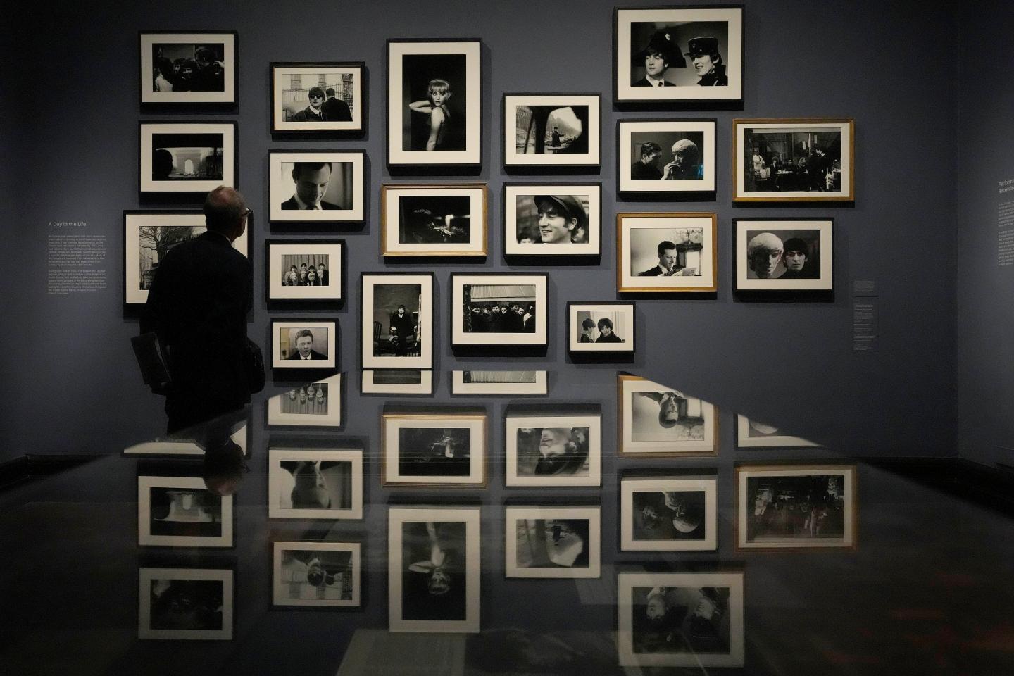 A visitor looks at pictures during a preview of Paul McCartney Photographs 1963-64: Eyes of the Storm exhibition.