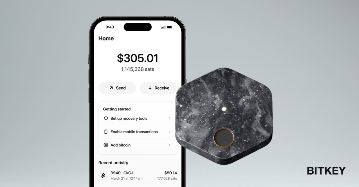 The Bitkey app juxtaposed to the hexagonal piece of hardware.