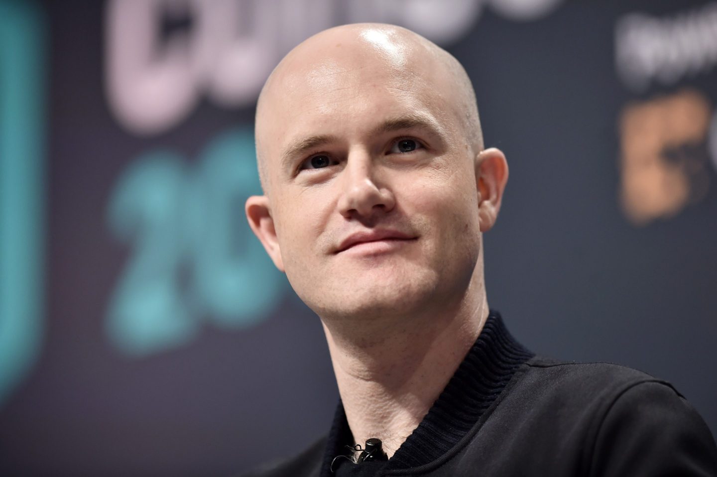 Brian Armstrong, founder and CEO of Coinbase, speaks on stage at a conference in 2019.