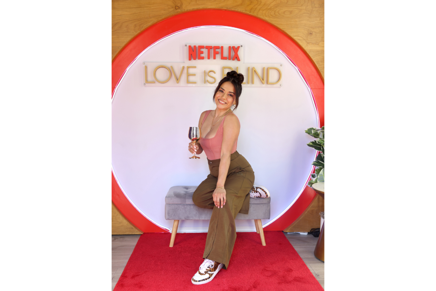 Nancy Rodriguez pictured in front of Netflix's Love Is Blind logo.
