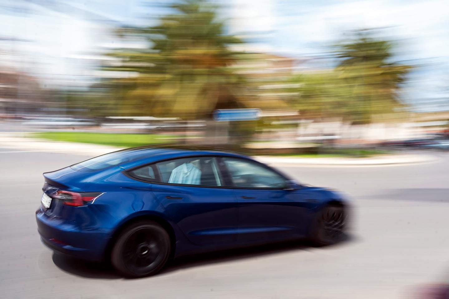 A Tesla car drives through the Port of Valencia.