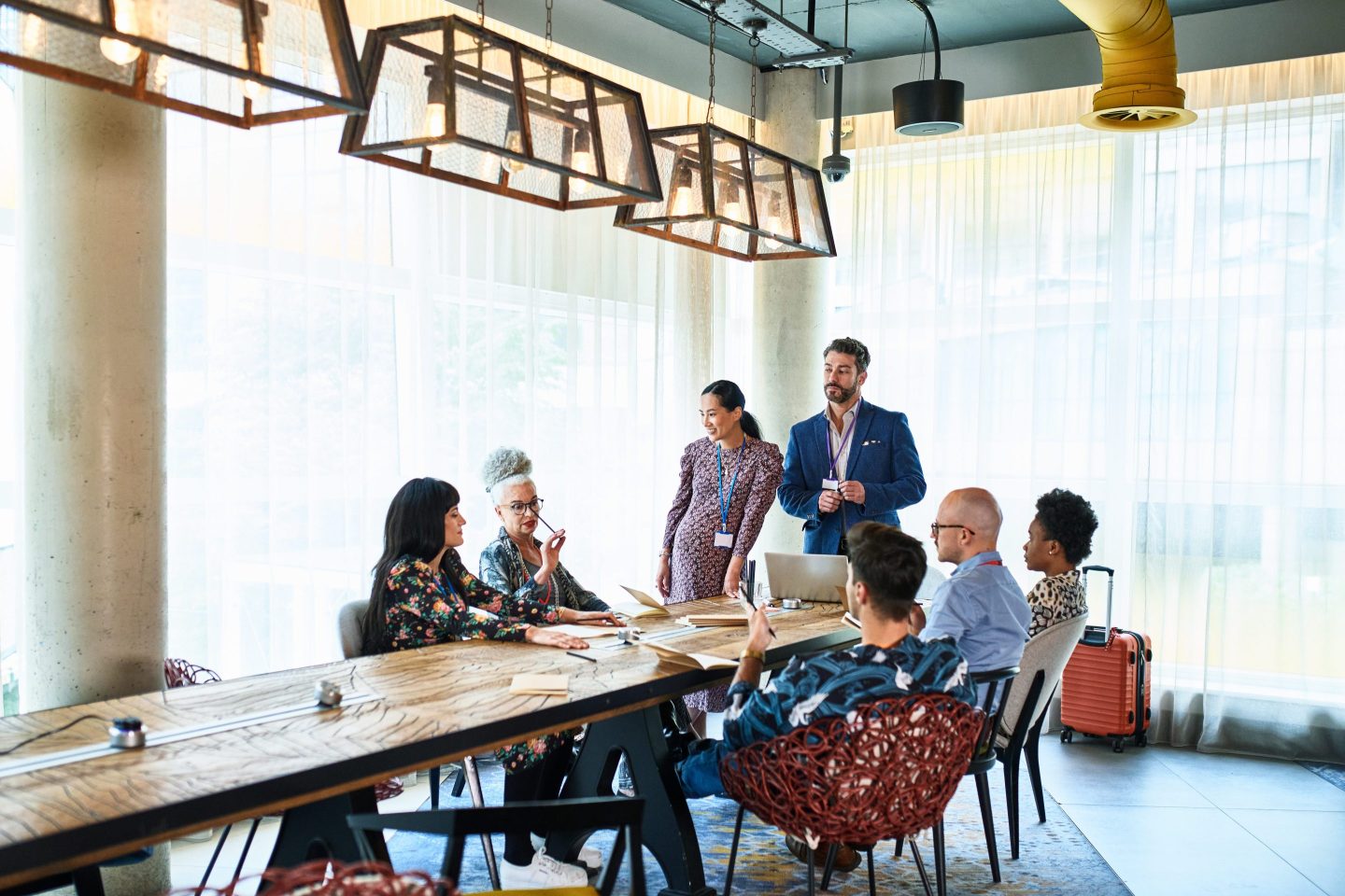A stock image depicting a diverse group of business colleagues meeting in a board room.