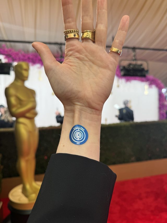 Photo of a hand with a blue disk on the wrist